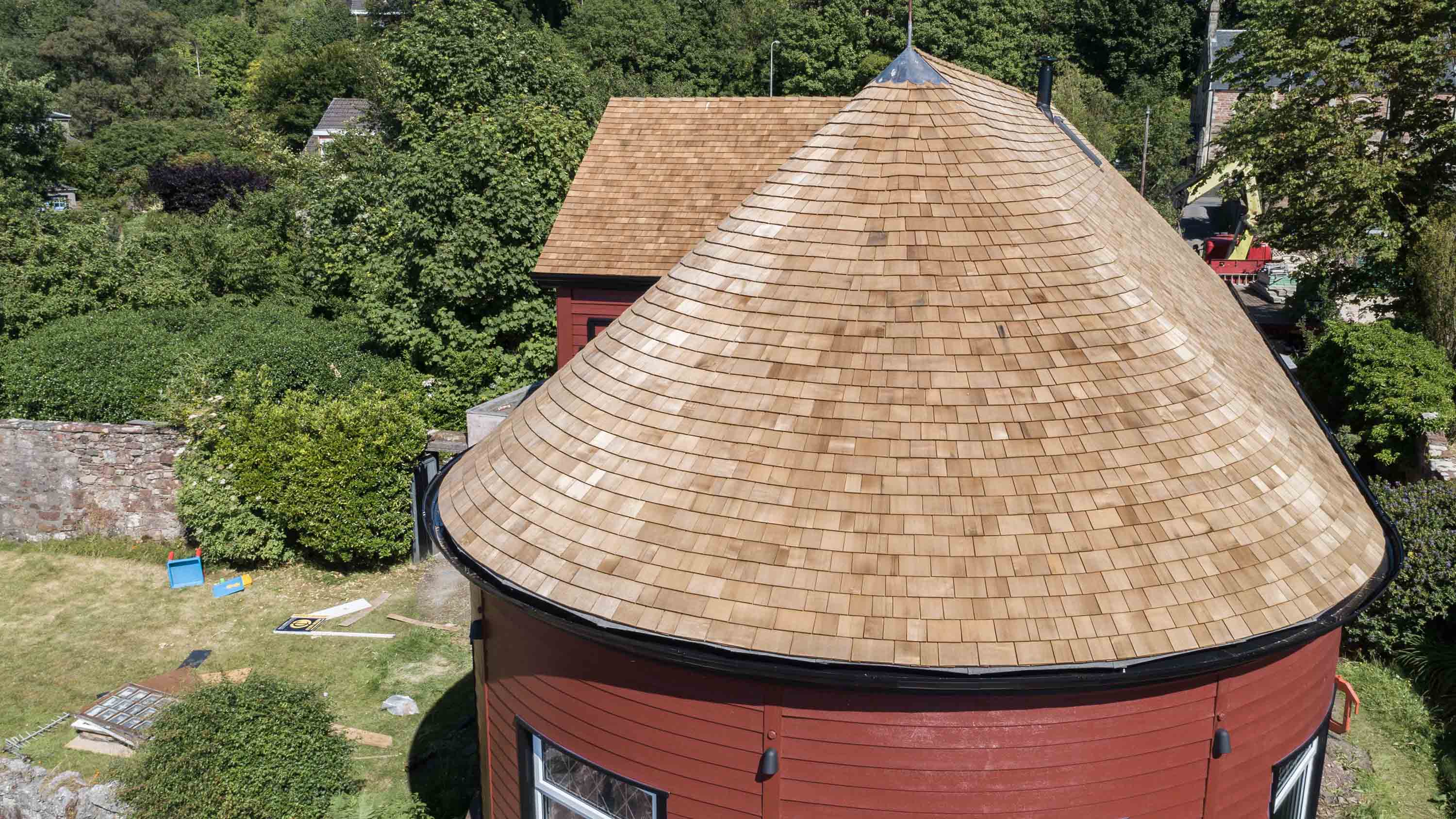 A house overlooking a cliff with a cedar shingle roof.